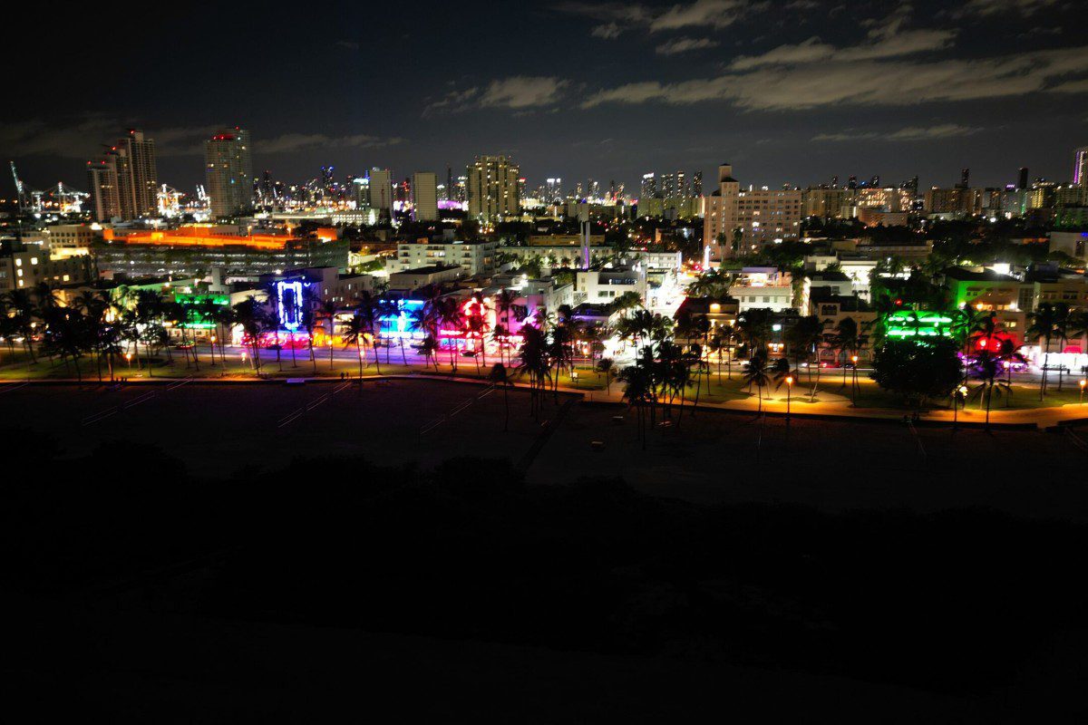 City skyline at night with colorful lights.