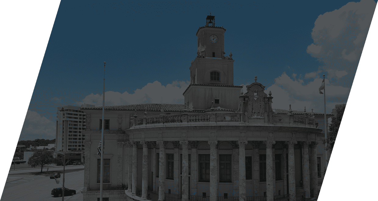 Historic building with columns and clock tower.