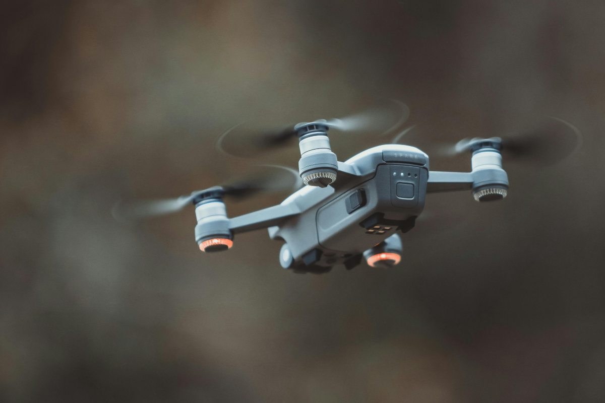 A drone flying outdoors with blurred background.